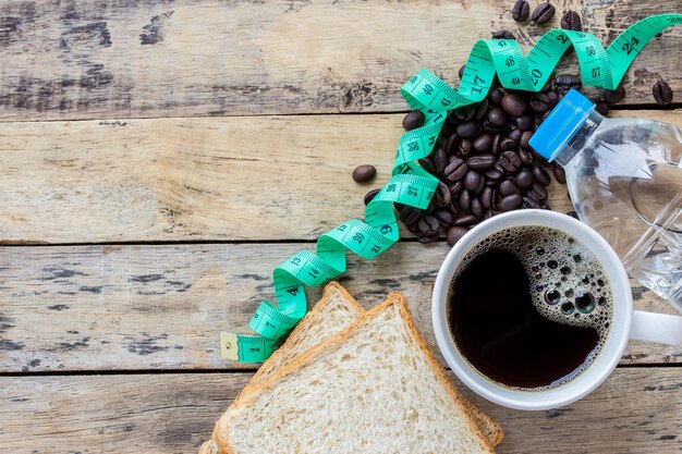 black coffee with a bread piece and an inches tape