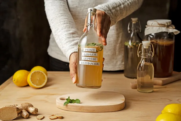 a man holding a Kombucha bottle.