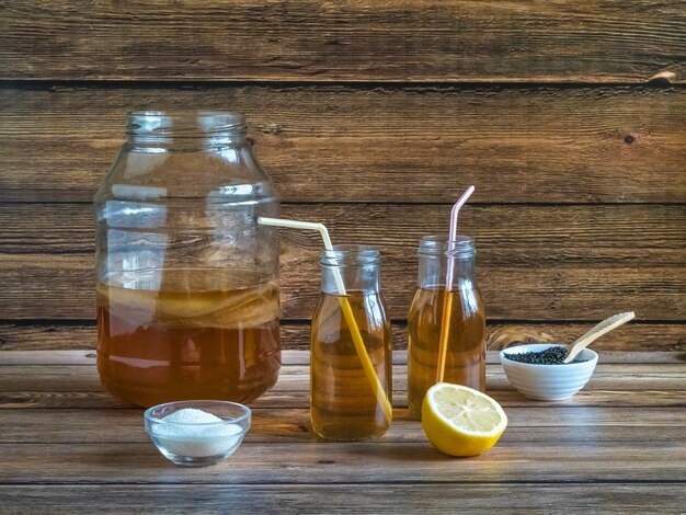 Kombucha bottle with lemon and salt in a small bowl.