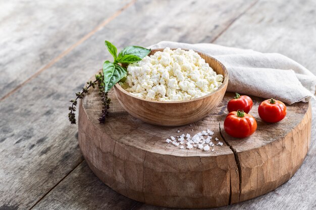 cottage cheese with seasoning in a wooden bowl