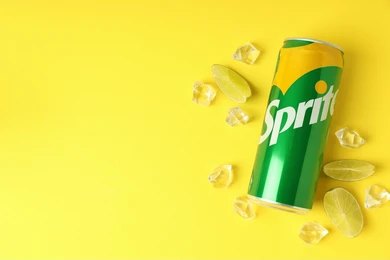 sprite tin can with lemon slices with yellow background