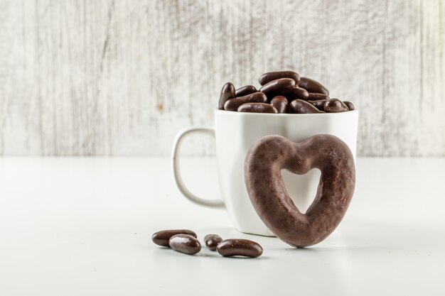 chocolate candies in a white cup.