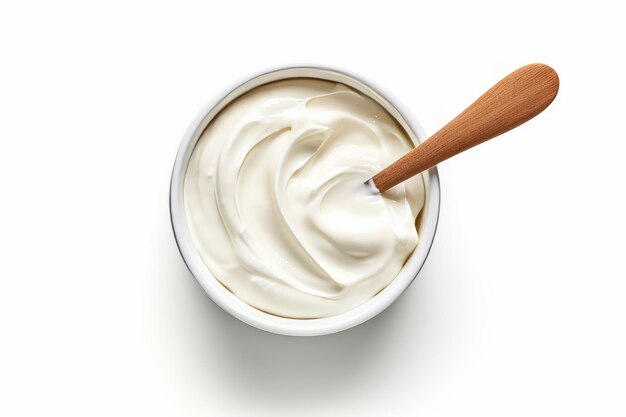 sour cream in a white bowl with a wooden spoon in it.