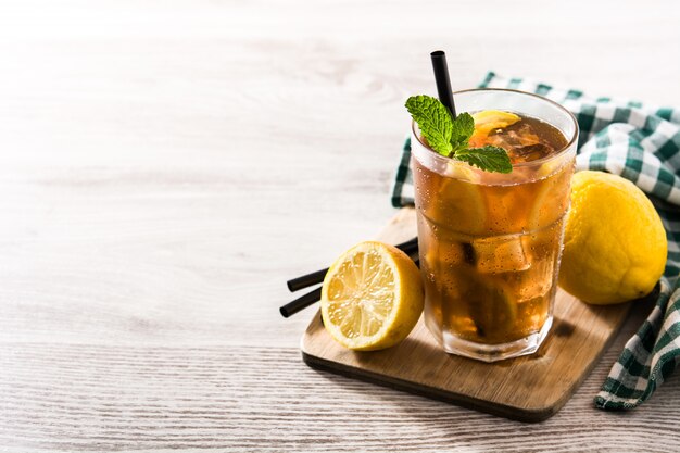 sweet tea in a cup placed on a wooden board.