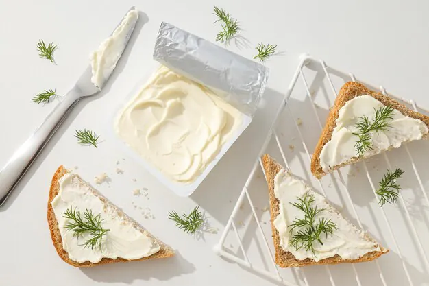 cheese cream in a plastic container with bread slices placed on a grid.