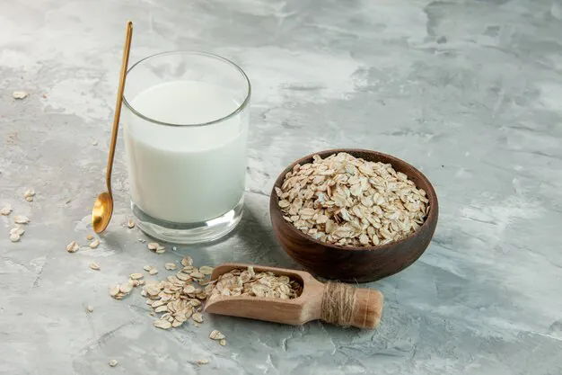 soy milk in a glass with soy seeds in a wooden bowl