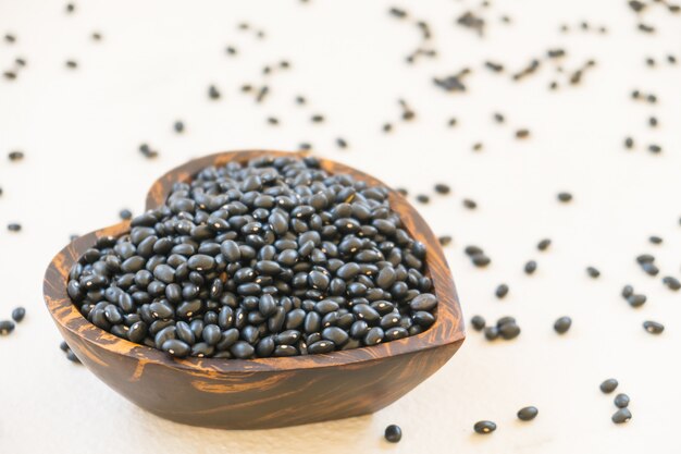 black beans in a wooden heart shaped bowl