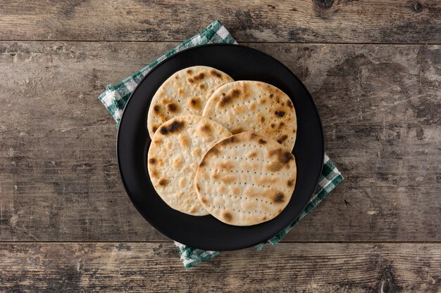 pita bread on a black circular plate