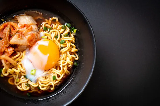 top half view of ramen in a black bowl